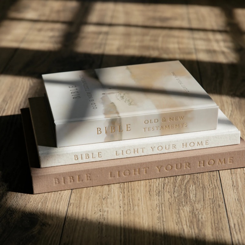 Bible and books in warm sunlight